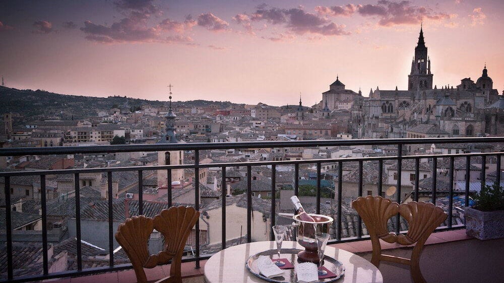 Terrace of Hotel Almunia de San Miguel with Toledo cathedral in the background